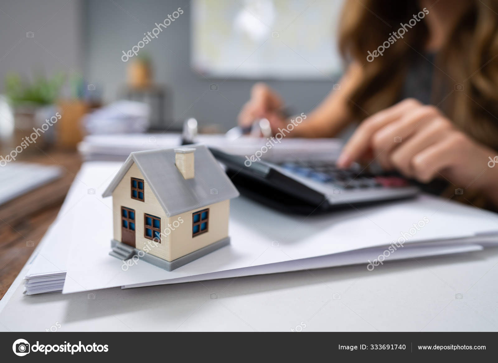 Businesswoman's Hand Calculating Invoice